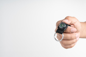 Hand holding metal hook with magnetic compass