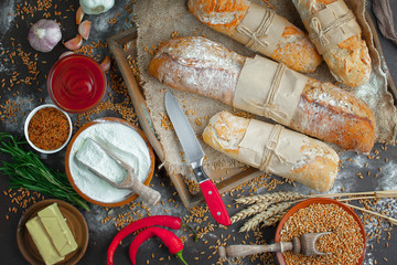 Bread in a composition with kitchen accessories on an old background
