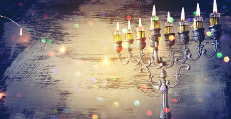 Religion image of jewish holiday Hanukkah background with menorah (traditional candelabra) and oil...