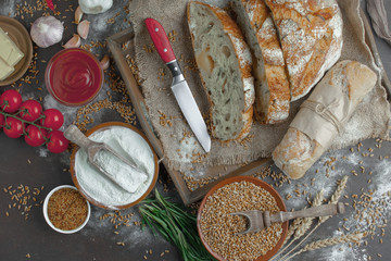 Bread in a composition with kitchen accessories on an old background