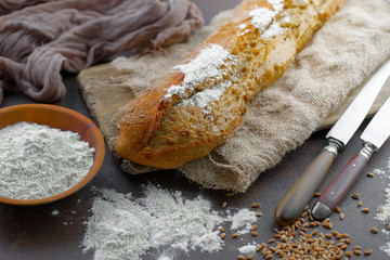 Bread in a composition with kitchen accessories on an old background
