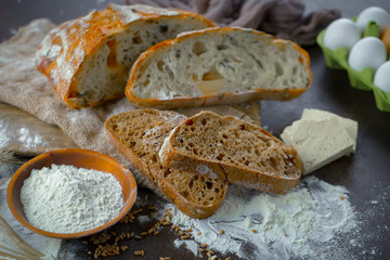 Bread in a composition with kitchen accessories on an old background