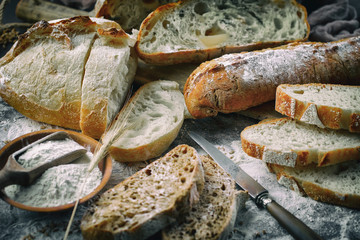 Bread in a composition with kitchen accessories on an old background