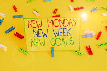 Word writing text New Monday New Week New Goals. Business photo showcasing showcasing next week resolutions To do list Colored clothespin papers empty reminder yellow floor background office