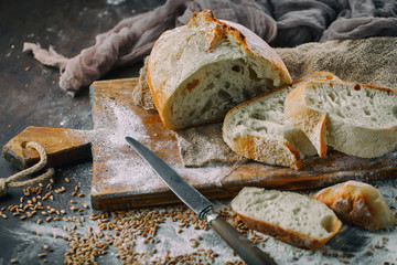 Bread in a composition with kitchen accessories on an old background