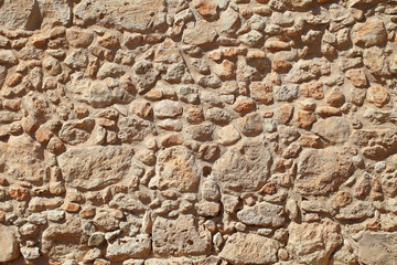 The wall of old stone masonry beige.