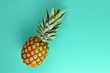 Summer background with hat and pineapple. Copy space.