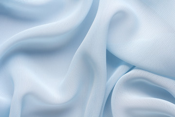 delicate blue fabric with large folds, textile background