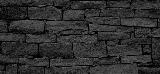 Hintergrund abstrakt Steine Steinmauer Mauer in schwarz und weiß und grau