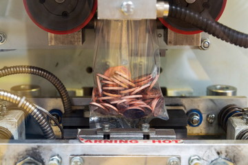 Coins manufactured and packed in money mint machine, steel galvanized with copper