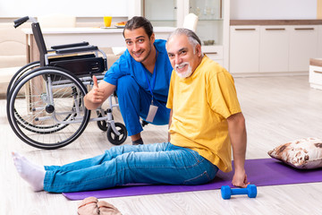 Young male doctor visiting old patient at home