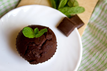 Top View of Chocolate Muffin with Mint Leaves on the Saucer in the Kitchen