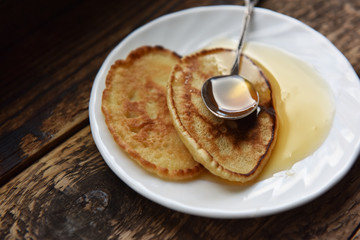 pancakes with honey and a silver spoon