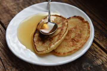 pancakes with honey and a silver spoon