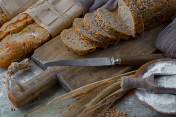 Bread in a composition with kitchen accessories on an old background