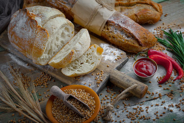 Bread in a composition with kitchen accessories on an old background