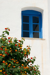 window in front of the house wall. Specific vintage scene in Greece, Mediterranean.