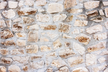 Masonry wall of stones with irregular pattern texture background