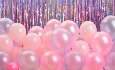 Pink and purple balloons on colorful background.