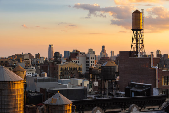 Summer Sunset light on Chelsea rooftops with water towers, Manhattan, New York City, NY, USA