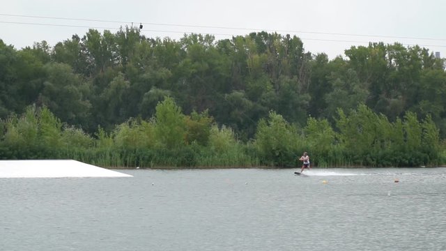 Rail slide on a ramp, slow motion footage of a wakeboarding trick