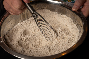 Cookie mix is stirred with a whisk in a bowl