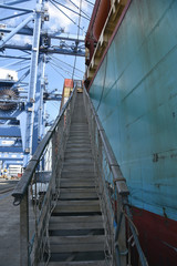 Fototapeta na wymiar Entrance to the cargo ship, through the gangway. 