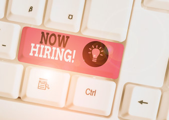 Word writing text Now Hiring. Business photo showcasing finding evaluating working relationship with future employees White pc keyboard with empty note paper above white background key copy space