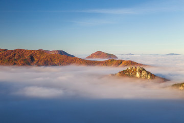 Mountain peaks over misty autumn landscape. Morning inversion in the Sulov rock mountains, Slovakia...