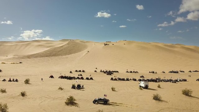 Aerial low angle Oldsmobile Hill and off highway vehicles riding sand dunes in California
