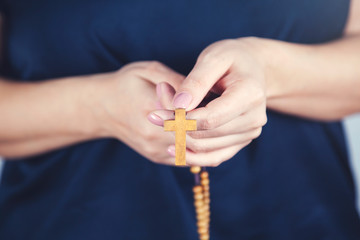 woman hand wooden cross