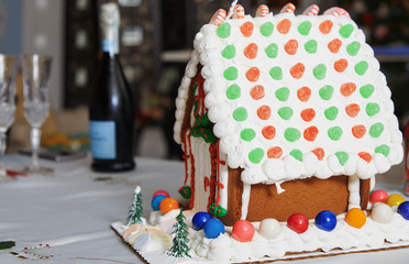 Christmas Gingerbread house on the table in Christmas decorated room
