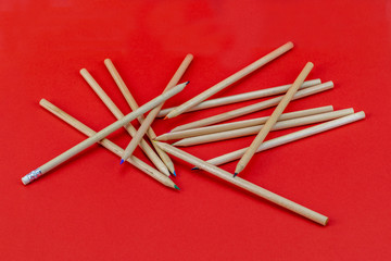 Wooden pencils on red background