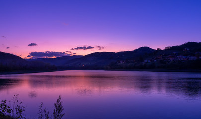 purple sky at sunset over mountain and lake landscape - 298930037