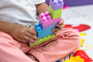 Close up of little boy hand playing and hold block building toys