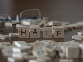 The concept of Half represented by wooden letter tiles