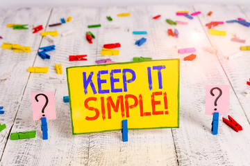 Text sign showing Keep It Simple. Business photo text ask something easy understand not go into too much detail Scribbled and crumbling sheet with paper clips placed on the wooden table