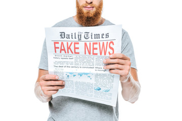 cropped view of serious man reading newspaper with fake news, isolated on white