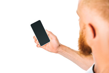 cropped view of man looking at smartphone with blank screen, isolated on white