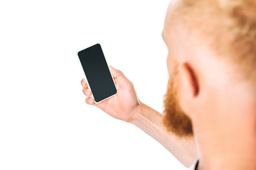 cropped view of man looking at smartphone with blank screen, isolated on white