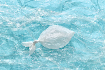 Fish made from plastic bag on a transparent polyethylene background.