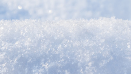 Background of fresh snow. Natural winter background. Snow texture in blue tone