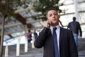businessman talking to mobile in urban environment
