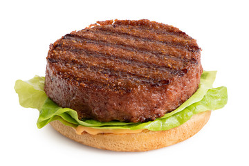 Freshly grilled plant based burger patty on bun with lettuce and sauce isolated on white.