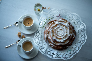 cup of coffee and cake on wooden table