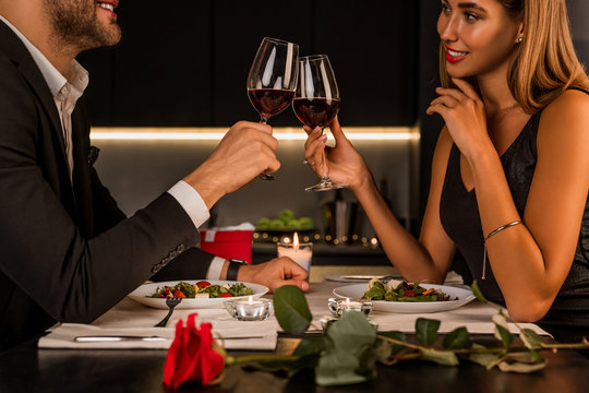 Happy Couple Toasting Wineglasses At Home Kitchen