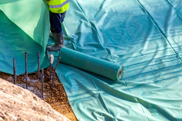 Installing polyethylene film barrier