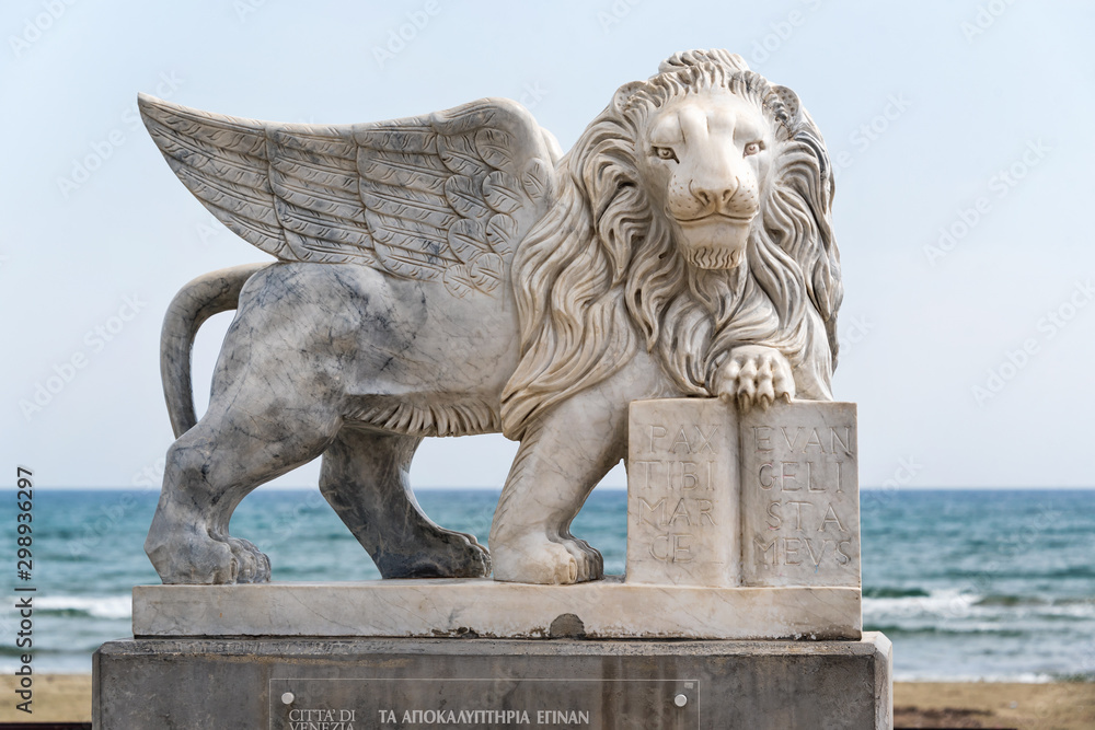 Wall mural Winged Lion of Venice statue at Foinikoudes promenade. Smiling lion monument, Larnaca. Cyprus