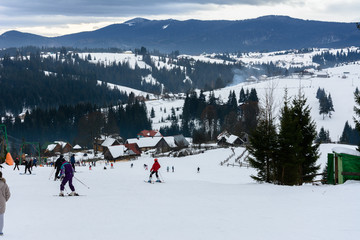 Skiers rest in the Ukrainian Carpathian village in winter.