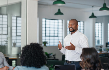 Smiling African American businessman having a meeting with his team